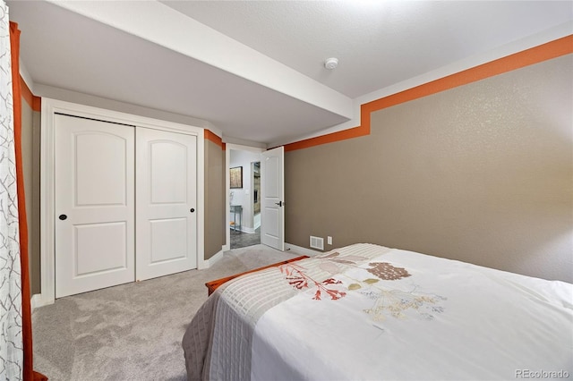 carpeted bedroom featuring a closet