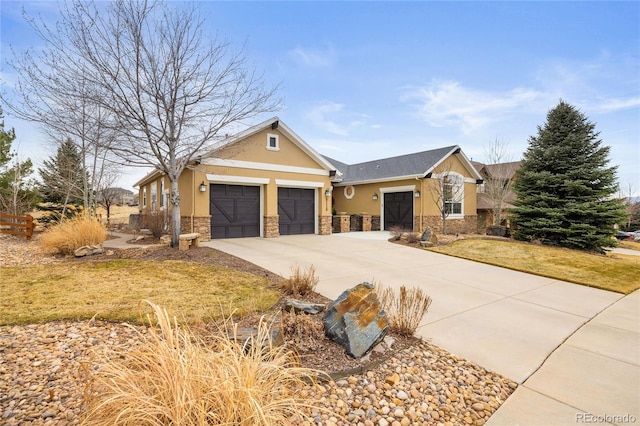 view of front of property featuring concrete driveway, a front yard, stucco siding, a garage, and stone siding