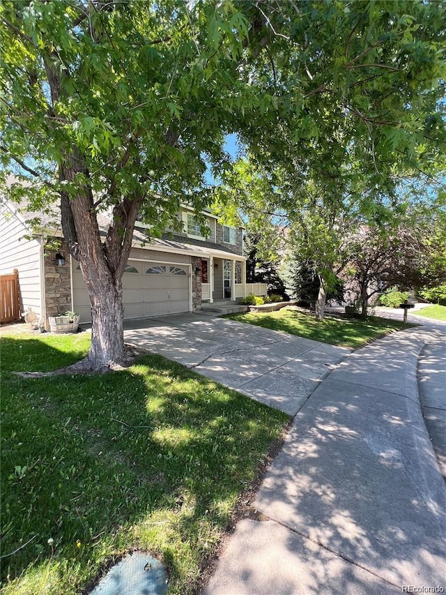 view of front of home with a front yard and a garage