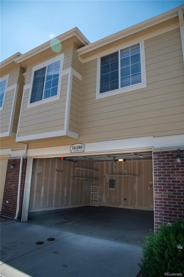 16180 E Geddes Ln Unit 14, Aurora, CO 80016 - view of front of house featuring brick siding, an attached garage, and concrete driveway