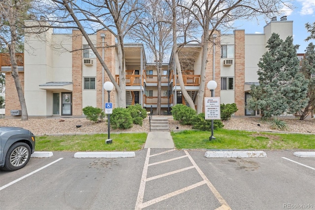 view of building exterior featuring uncovered parking