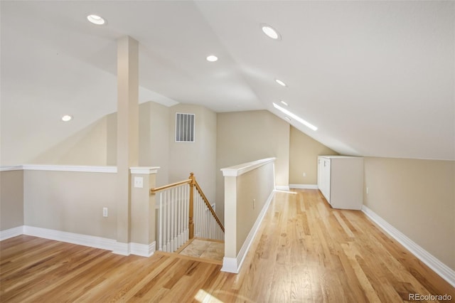 additional living space with lofted ceiling, visible vents, light wood finished floors, and recessed lighting