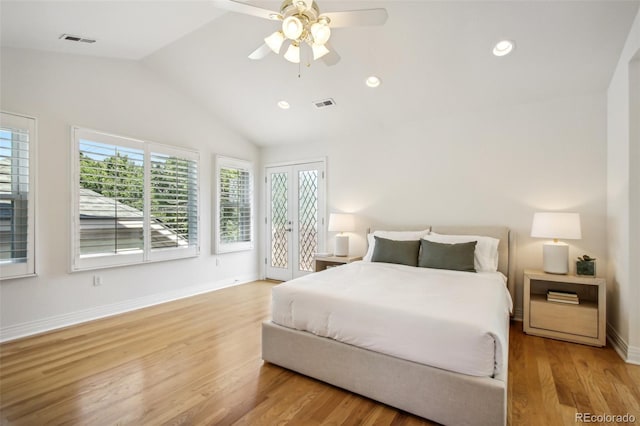 bedroom featuring visible vents, vaulted ceiling, baseboards, and wood finished floors