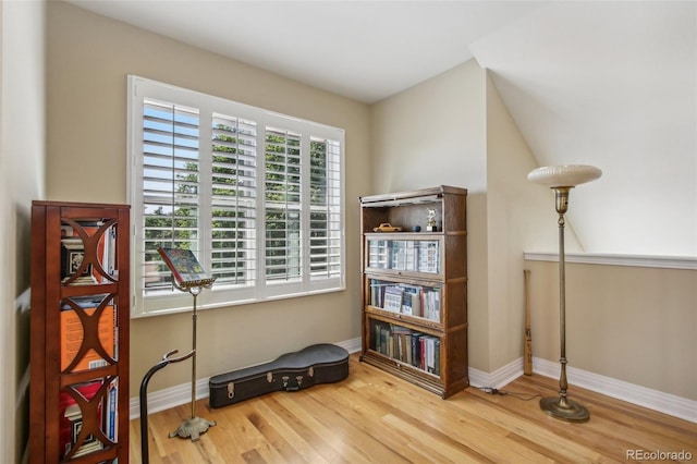 interior space featuring baseboards and wood finished floors