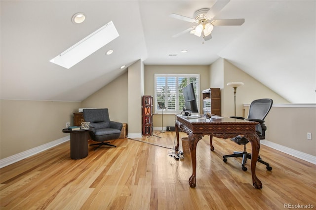 office area with lofted ceiling with skylight, recessed lighting, wood finished floors, and baseboards