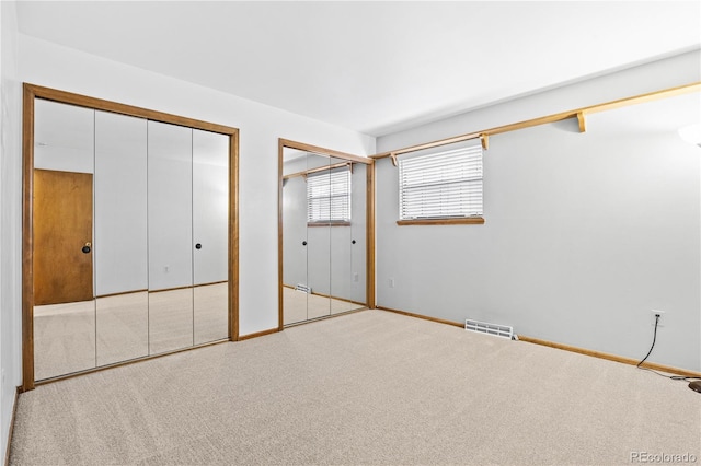 7888 S Poplar Way, Centennial, CO 80112 - unfurnished bedroom with multiple closets and carpet flooring