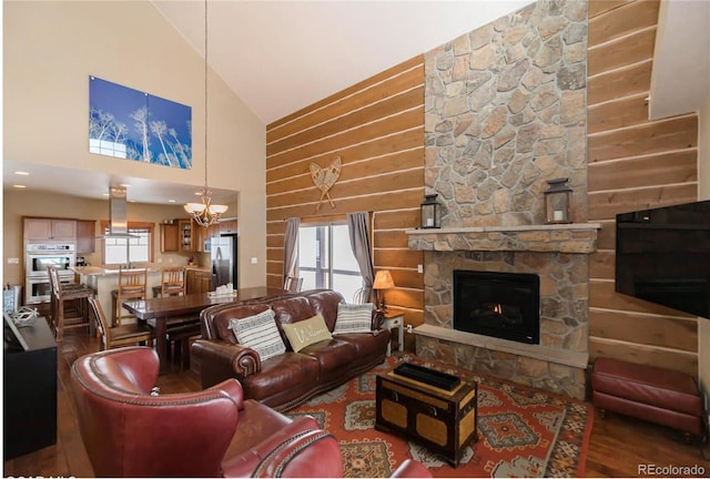 living room featuring a fireplace, hardwood / wood-style floors, high vaulted ceiling, and a healthy amount of sunlight