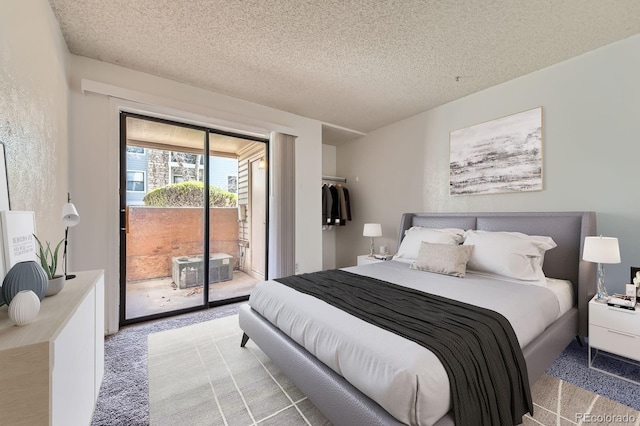 bedroom featuring a textured ceiling, a textured wall, light colored carpet, and access to outside