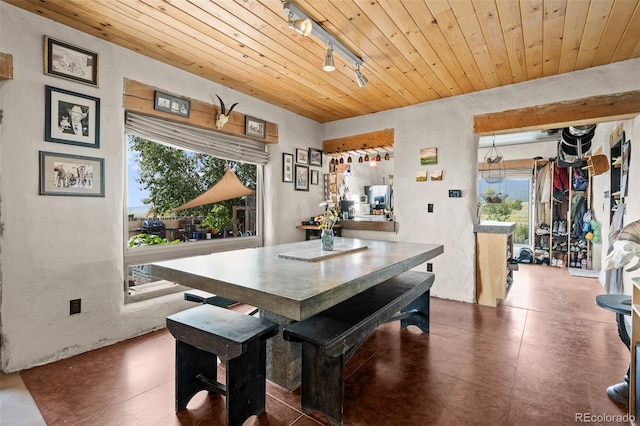 dining space featuring wooden ceiling and rail lighting