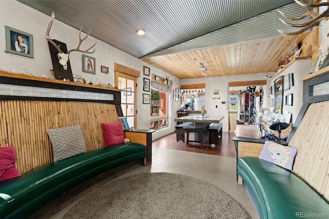 sitting room featuring concrete flooring and wood ceiling