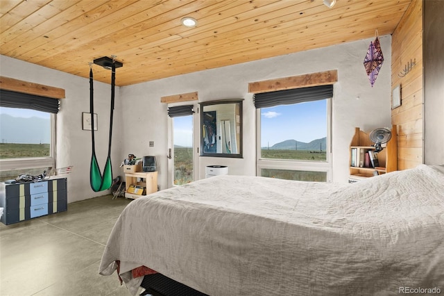 bedroom featuring a mountain view and wooden ceiling