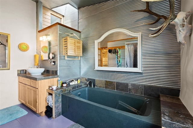 bathroom featuring a washtub and vanity