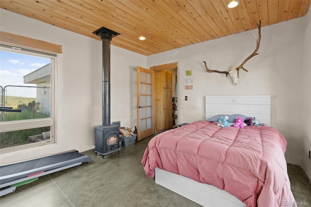 bedroom featuring wooden ceiling and a wood stove