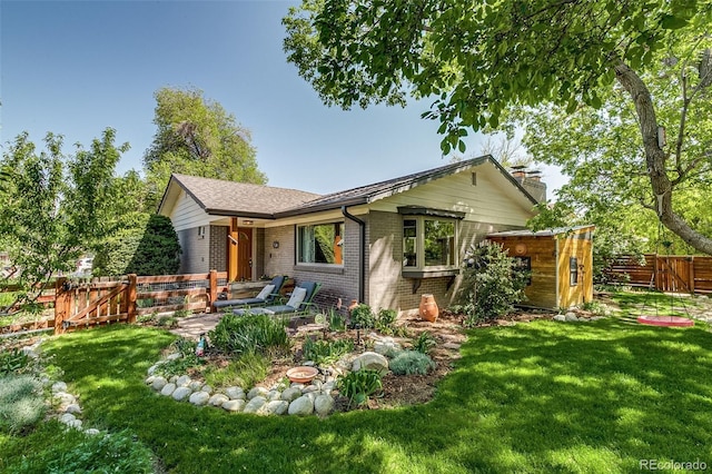 3010 Zinnia Ct, Golden, CO 80401 - view of front facade with brick siding, a gate, a shed, an outbuilding, and a chimney