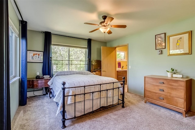 3010 Zinnia Ct, Golden, CO 80401 - bedroom with light colored carpet, ceiling fan, and connected bathroom