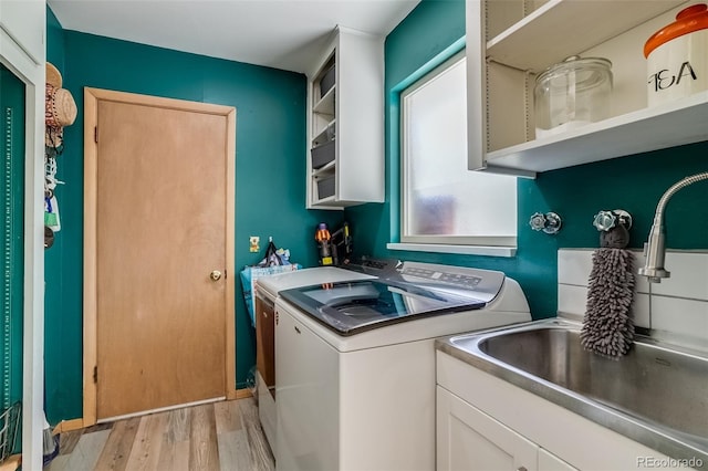3010 Zinnia Ct, Golden, CO 80401 - laundry room with light wood finished floors, washing machine and dryer, and cabinet space