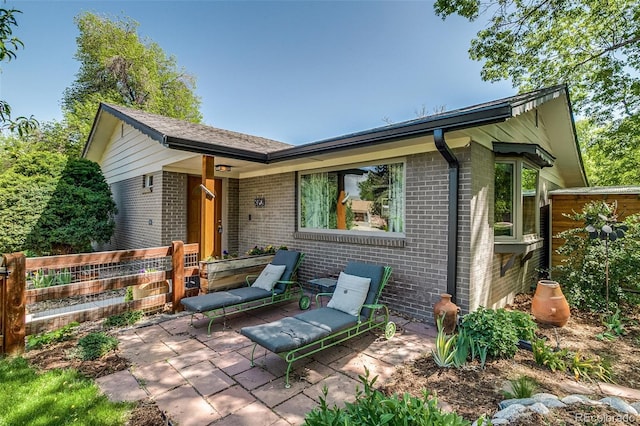 3010 Zinnia Ct, Golden, CO 80401 - view of front of house featuring brick siding, fence, and a patio