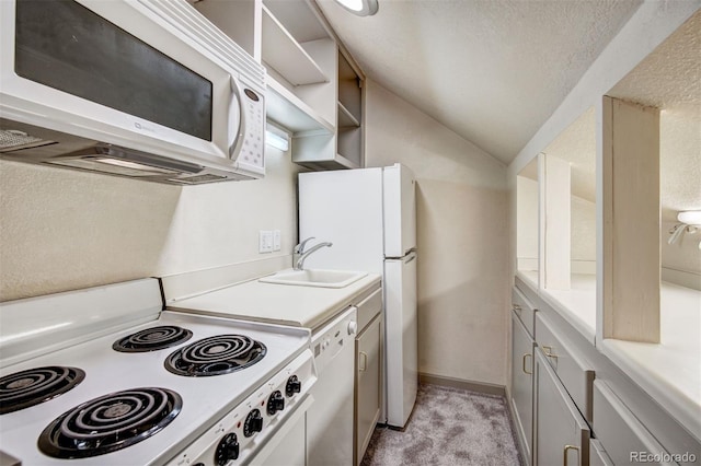 kitchen featuring light carpet, white appliances, vaulted ceiling, white cabinets, and sink