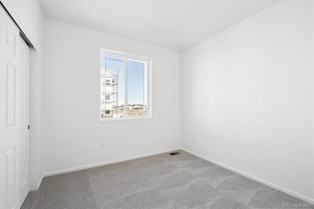 unfurnished bedroom featuring a closet and light carpet