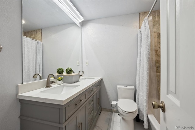 full bathroom with double vanity, curtained shower, a sink, and toilet