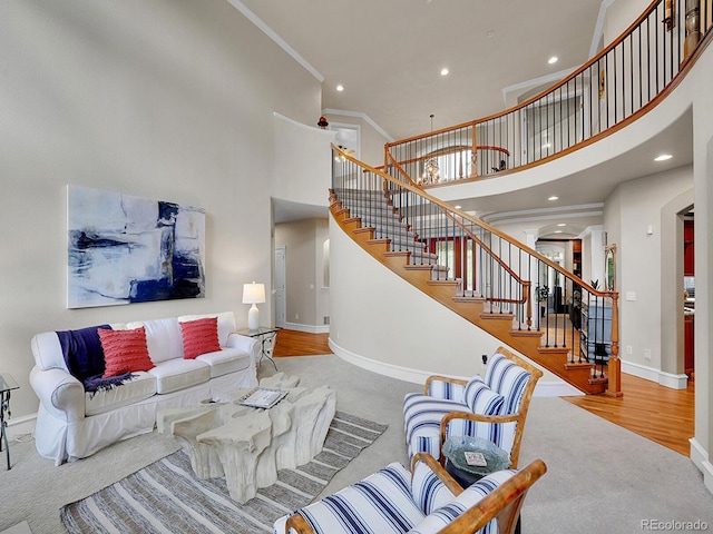 291 Fairchild Dr, Highlands Ranch, CO 80126 - carpeted living room featuring a towering ceiling, stairway, baseboards, ornamental molding, and recessed lighting