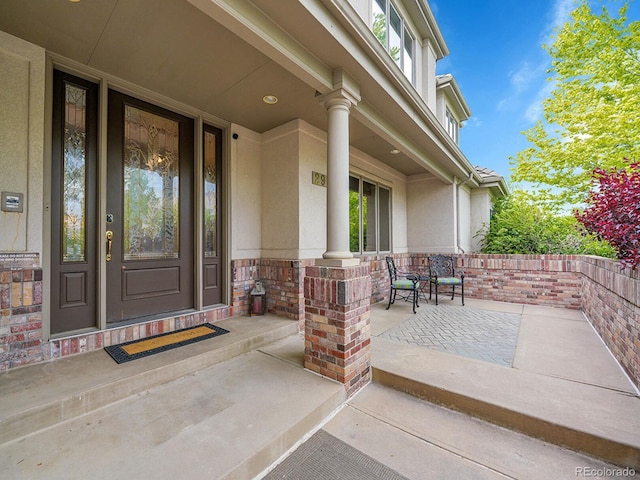 291 Fairchild Dr, Highlands Ranch, CO 80126 - view of exterior entry with covered porch, stucco siding, and stone siding