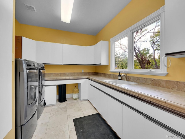 291 Fairchild Dr, Highlands Ranch, CO 80126 - laundry area with separate washer and dryer and cabinet space