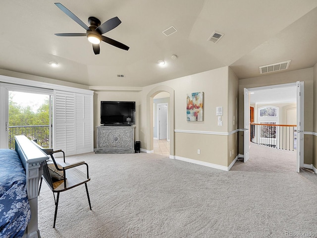 291 Fairchild Dr, Highlands Ranch, CO 80126 - living area with arched walkways, a ceiling fan, light colored carpet, and baseboards