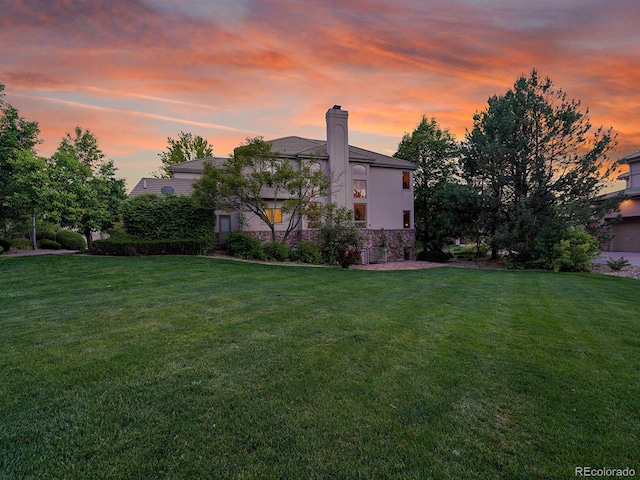 291 Fairchild Dr, Highlands Ranch, CO 80126 - yard at dusk with a yard