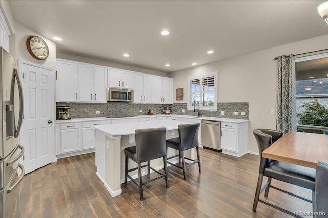 3762 White Rose Loop, Castle Rock, CO 80108 - kitchen with appliances with stainless steel finishes, dark wood-type flooring, decorative backsplash, white cabinetry, and recessed lighting