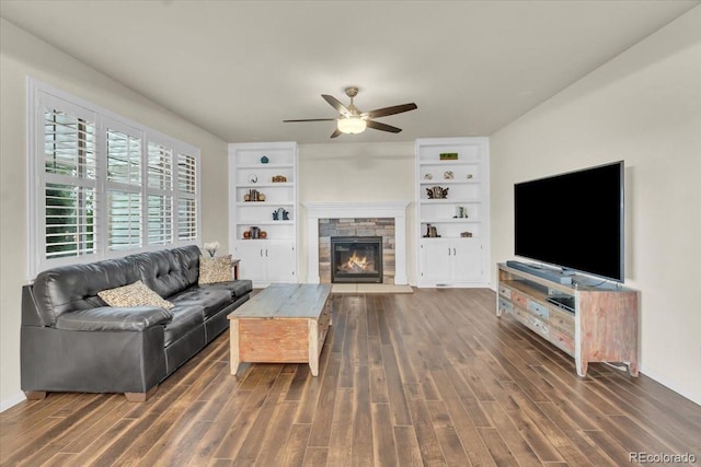 3762 White Rose Loop, Castle Rock, CO 80108 - living area featuring ceiling fan, dark wood-style flooring, a stone fireplace, and built in features