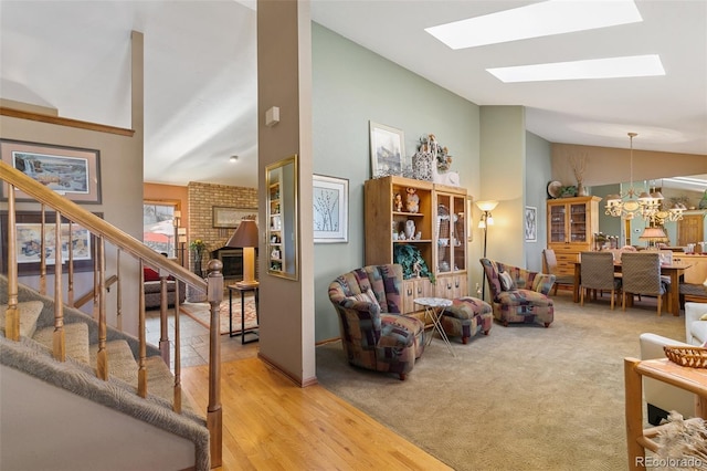 1045 Golden Hills Rd, Colorado Springs, CO 80919 - living room featuring stairs, a brick fireplace, high vaulted ceiling, a chandelier, and a skylight