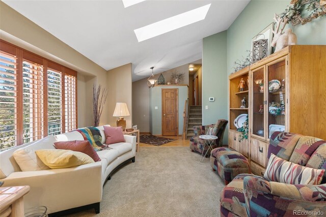 1045 Golden Hills Rd, Colorado Springs, CO 80919 - living room with carpet floors, stairs, and lofted ceiling with skylight