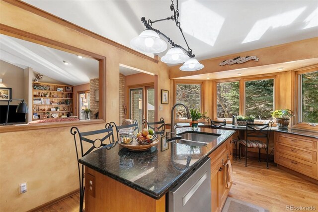 1045 Golden Hills Rd, Colorado Springs, CO 80919 - kitchen with a sink, dishwasher, light wood-style flooring, dark stone countertops, and lofted ceiling