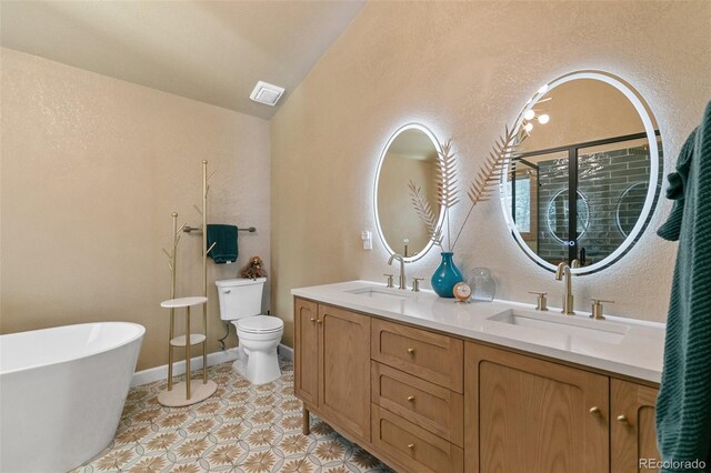 1045 Golden Hills Rd, Colorado Springs, CO 80919 - full bathroom featuring a sink, visible vents, toilet, and lofted ceiling