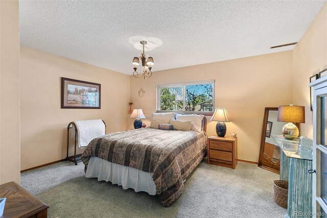 1045 Golden Hills Rd, Colorado Springs, CO 80919 - bedroom with a textured ceiling, baseboards, a chandelier, and carpet
