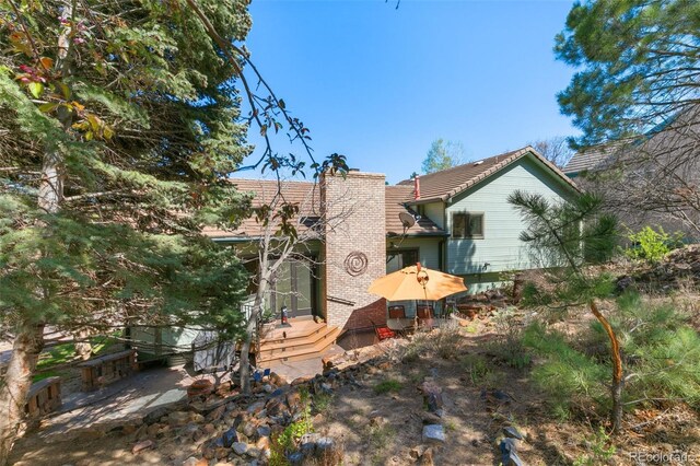 1045 Golden Hills Rd, Colorado Springs, CO 80919 - rear view of property featuring a chimney and a tile roof