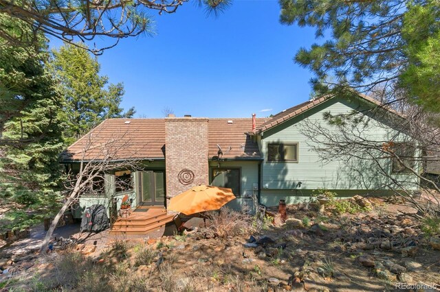 1045 Golden Hills Rd, Colorado Springs, CO 80919 - back of house with a wooden deck and a chimney
