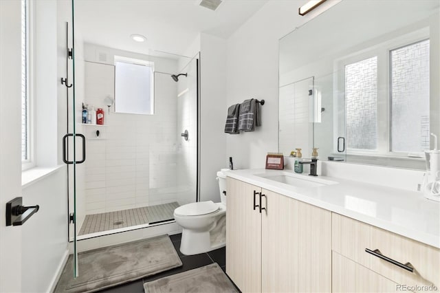 bathroom with a wealth of natural light, vanity, an enclosed shower, and toilet