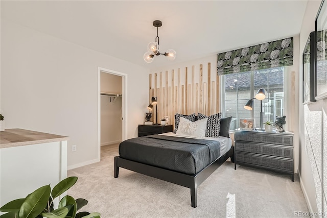 5572 Runge Ct, Timnath, CO 80547 - bedroom featuring baseboards, a chandelier, a walk in closet, and light colored carpet