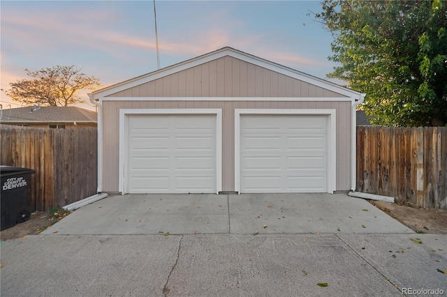 view of garage at dusk