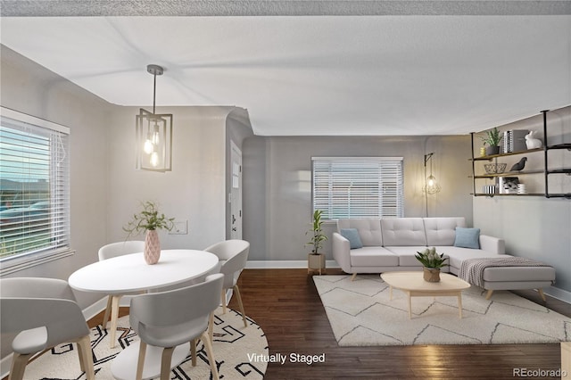 living room featuring dark hardwood / wood-style flooring and a textured ceiling