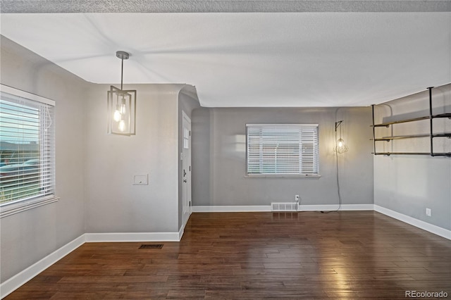 interior space with dark hardwood / wood-style floors and a textured ceiling