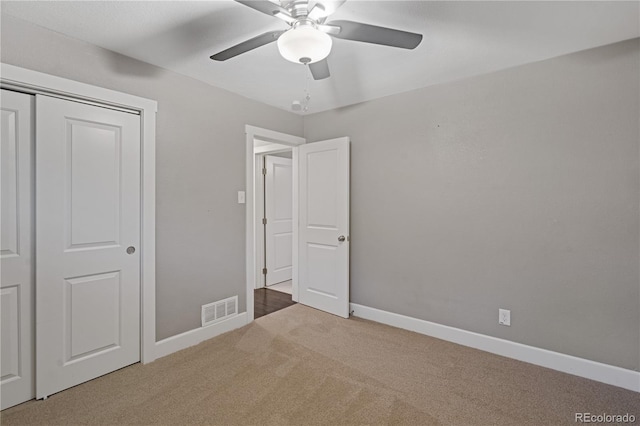 unfurnished bedroom with ceiling fan, carpet floors, and a closet