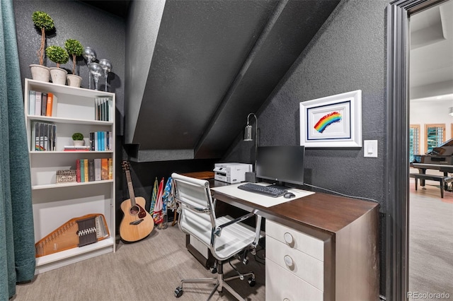 home office featuring lofted ceiling and light colored carpet