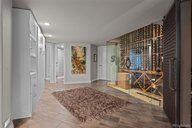 wine area with hardwood / wood-style floors and a textured ceiling