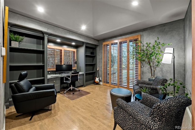 office featuring built in shelves and light hardwood / wood-style flooring