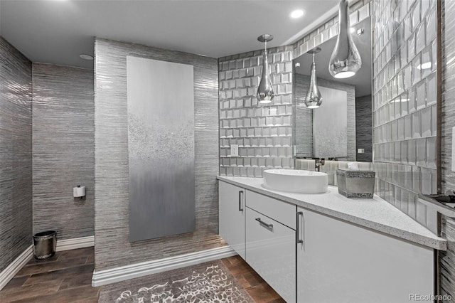 bathroom with vanity and tile walls