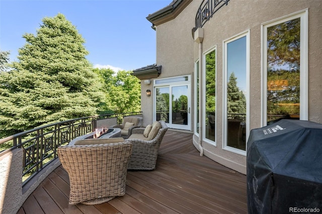 wooden deck featuring a grill