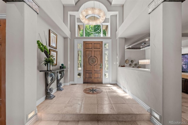 entryway featuring a chandelier and a high ceiling